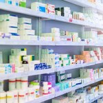 Pharmacy, shelf and boxes for product, empty or pharmaceutical stock for wellness, health and interior. Shop, store and retail healthcare with storage, choice or sale for wellness, discount and drugs.