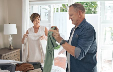 Photo for Your help is always welcome. a mature couple folding laundry together - Royalty Free Image