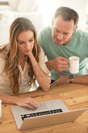 Photo for Laptop, home planning and couple reading or scroll on internet together for online, website or application at table. Mature partner, woman or people on computer or pc, coffee or tea in the morning. - Royalty Free Image