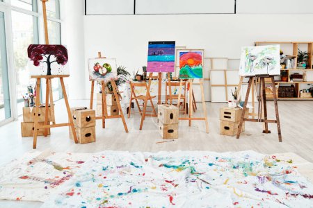 Photo for The aftereffect of an art class. painted canvas on easels in an empty studio after an art class during the day - Royalty Free Image