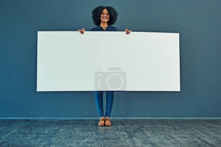 Photo for Banner, mockup and portrait of happy woman in studio with billboard for news, social media or advertising on blue background. Space, paper and girl smile with poster, sign and branding promotion. - Royalty Free Image