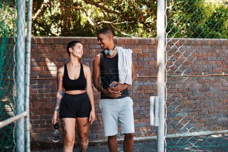 Photo for Are you ready for todays session. two sporty young people chatting to each other while walking into a sports court - Royalty Free Image