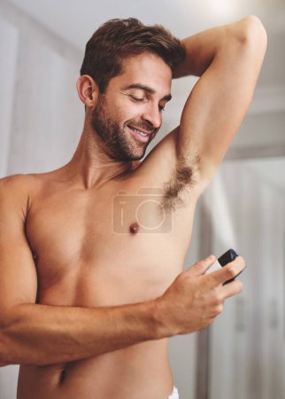 Photo for Deodorant, clean spray and man in bathroom for hygiene, shower and perfume to control underarm sweating. Happy shirtless guy, armpit and fragrance cosmetics for skincare, body product and male beauty. - Royalty Free Image