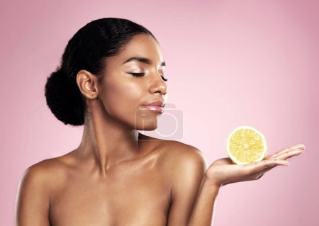 Photo for Lemon, natural beauty and woman in studio, pink background and mockup of nutrition. African model, healthy skincare and citrus fruit of sustainable cosmetics, vegan dermatology and vitamin c benefits. - Royalty Free Image