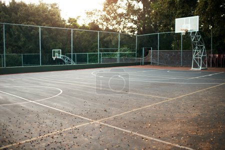 Let the games begin. an empty basketball court after a match during the day