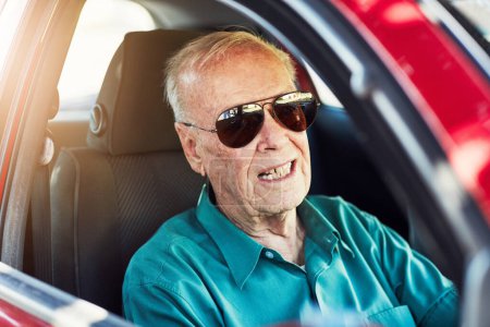 Photo for Live your life and forget your age. Cropped portrait of a senior man wearing sunglasses while driving his car - Royalty Free Image