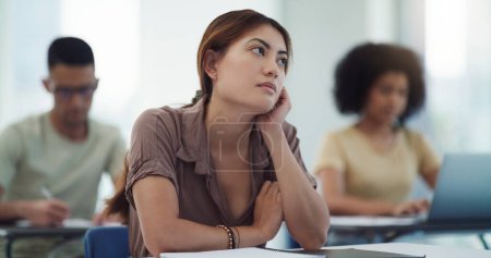 Photo for Education, depression and girl university student in a classroom bored, adhd or daydreaming during lecture. Thinking, anxiety and female learner distracted in class, contemplation, boredom or sad. - Royalty Free Image