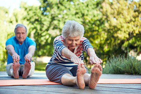 Photo for Nature, yoga stretching and senior couple start outdoor exercise, training workout or health fitness on park floor. Wellness, freedom and elderly marriage people, man or woman doing pilates warm up. - Royalty Free Image