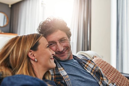 Photo for Face of couple, smile and relax in living room for quality time, love and care of support together at home. Happy man, mature woman and bonding on sofa for break, happiness or loyalty to life partner. - Royalty Free Image