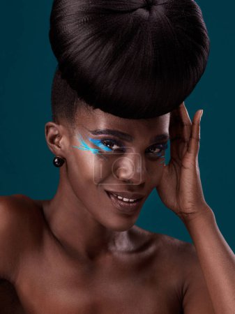 Photo for Portrait, makeup and happy with an african woman in studio on a blue background for hair or cosmetics. Eyeshadow, smile and fashion with an attractive young female model at the salon for style. - Royalty Free Image