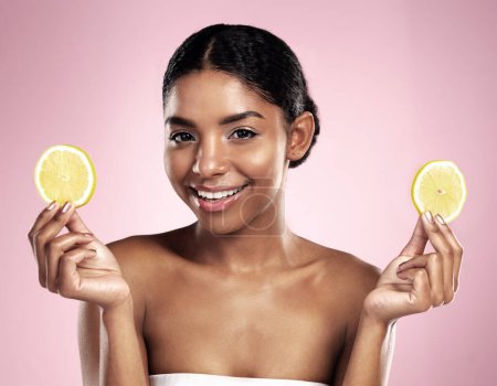 Photo for Portrait of happy woman, lemon and skincare in studio, pink background or wellness of vitamin c benefits. Face of african model, citrus fruits and nutrition of beauty, organic cosmetics or detox diet. - Royalty Free Image