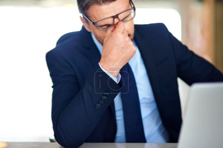 Photo for All work and no play. a businessman experiencing stress at the office - Royalty Free Image