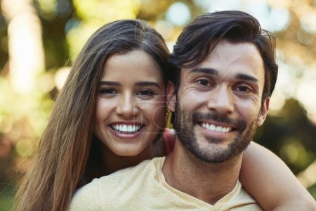 Photo for The closer we are, the happier we are. Portrait of a happy young couple posing together outside - Royalty Free Image