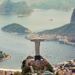 Brazil landscape, city and Christ the Redeemer on hill for tourism, sightseeing and travel destination. Traveling, Rio de Janeiro and aerial view of statue, sculpture and global landmark on mountain.