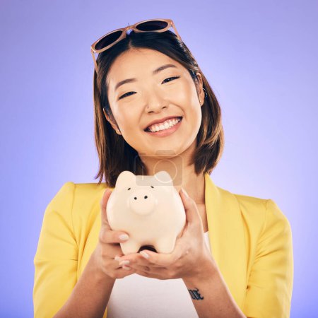 Photo for Piggy bank, saving and portrait of Asian woman in studio for investment, financial profit and budget. Finance, banking and face of happy female person with money container for savings, cash and coins. - Royalty Free Image