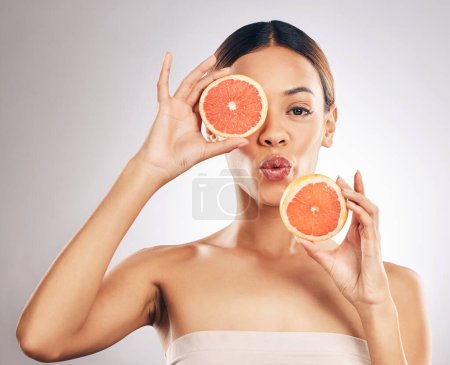 Photo for Skincare, portrait and woman with grapefruit in studio for for organic, cosmetic or treatment on grey background. Fruit, face and female model with fruit for eco, vegan and skin detox with vitamin c. - Royalty Free Image