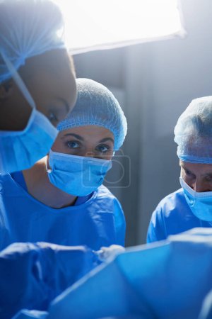 Photo for Surgery, operating room and portrait of woman doctor with team, healthcare and teamwork in professional medicine. Medical innovation, emergency and focus, surgeon with expert staff in hospital icu - Royalty Free Image