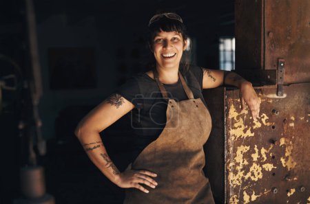 Photo for Woman blacksmith, portrait and happy in workshop for industry, trade or entrepreneurship in foundry. Small business owner, female entrepreneur or labor in factory, industrial warehouse or metalwork. - Royalty Free Image