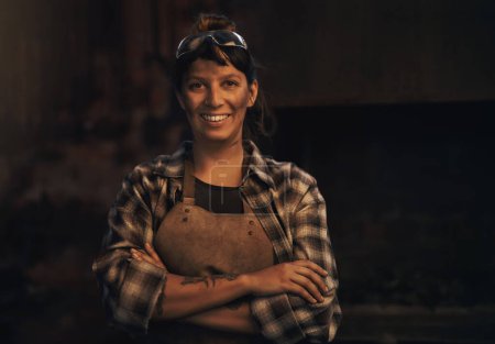 Photo for Woman blacksmith, portrait and smile in workshop, industrial warehouse or trade with entrepreneurship. Small business owner, female entrepreneur or confident in factory, industry or metalwork artisan. - Royalty Free Image