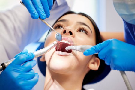 Photo for A little maintenance goes a long way. a young woman having a dental procedure performed on her - Royalty Free Image