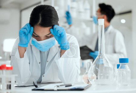 Photo for When nothing seems to be working. a young scientist looking stressed out with a headache - Royalty Free Image