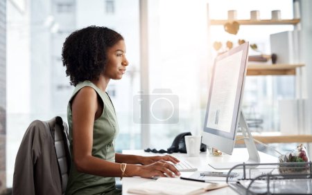 Photo for Computer, typing and business woman in office for online research, copywriting and editing for job website. Young african person, editor or journalist on desktop pc or monitor for article or report. - Royalty Free Image