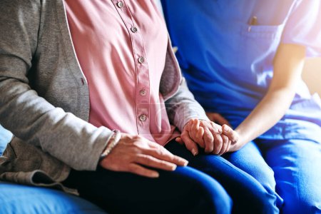 Photo for Im here to help you through this. a nurse holding a senior womans hands in comfort - Royalty Free Image