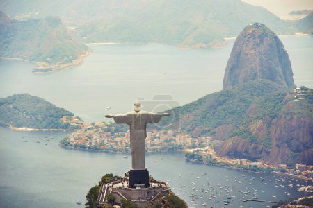 Photo for Statue, monument and Christ the Redeemer on mountain for tourism, sightseeing and travel destination. Traveling, Rio de Janeiro and aerial view of symbol, sculpture and city landmark by Brazil ocean. - Royalty Free Image