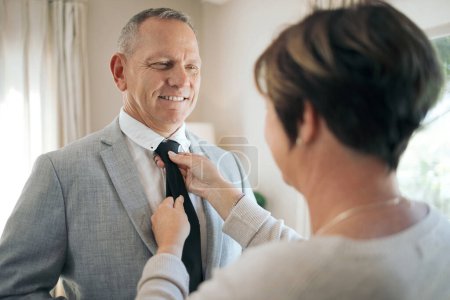 Photo for You look so debonair. a mature woman helping her husband fix his tie - Royalty Free Image