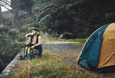 Photo for Escaping into the beauty of nature. a young man drinking coffee while camping in the wilderness - Royalty Free Image