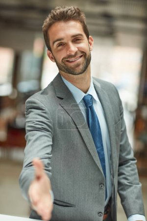 Photo for Shall we shake on it. Cropped portrait of a handsome young businessman standing alone and extending his hand for a handshake - Royalty Free Image