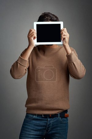 Photo for Tablet screen, space and man covering face in studio isolated on a gray background. Touchscreen, hiding and male person with mockup for marketing, advertising and technology for commercial promotion - Royalty Free Image