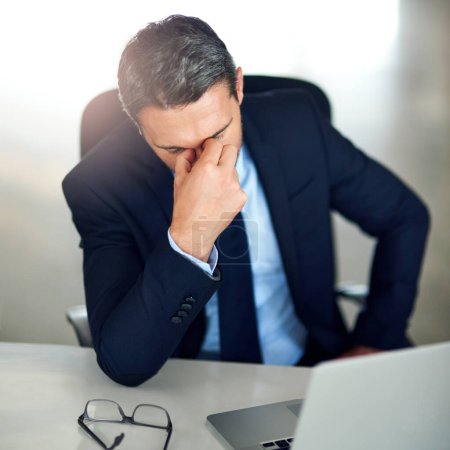 Photo for Zero motivation. a businessman experiencing stress at the office - Royalty Free Image