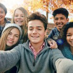 Friends, teenager and group selfie in the park, nature or fall trees and teens smile, picture of friendship and happiness for social media. Portrait, face and happy people together for autumn photo.