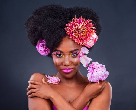 Photo for Flowers, portrait and black woman with makeup in studio for organic beauty on dark background. Floral, face and African lady model smile for eco friendly, natural and cosmetics with isolated mockup. - Royalty Free Image