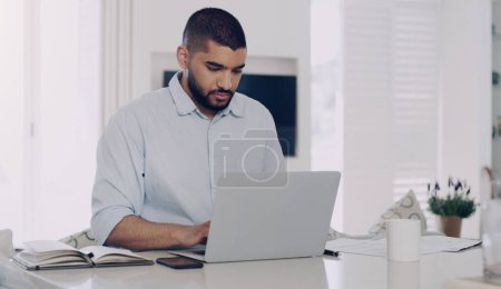 Photo for Man, remote work and typing at laptop in home for digital planning, online research and information at table. Male freelancer working on computer technology, internet and reading email for budget. - Royalty Free Image