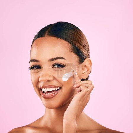 Photo for Happy woman, portrait smile and skincare cream for beauty moisturizer against a pink studio background. Female person or model smiling in happiness for lotion, cosmetic products or facial treatment. - Royalty Free Image