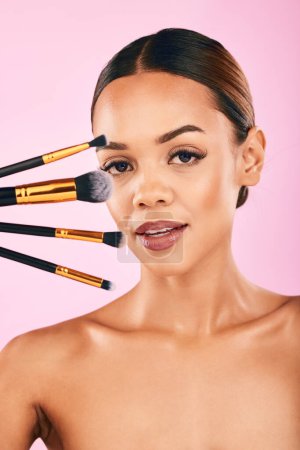 Photo for Woman, portrait and makeup brushes for beauty cosmetics against a pink studio background. Isolated female person or model with cosmetic tools or equipment for grooming, products or facial treatment. - Royalty Free Image