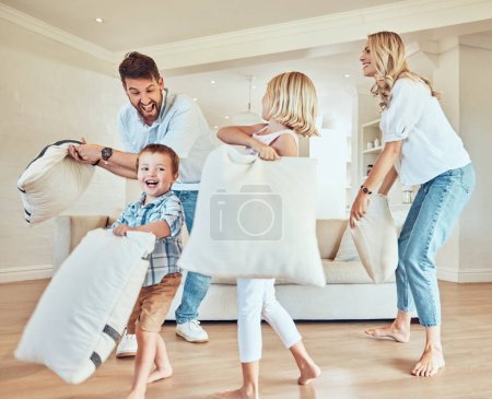 Photo for Pillow fight, happy parents and kids playing in living room with energy, funny game or joke together at home. Excited mom, dad and playful children with pillows, crazy morning and happiness of family. - Royalty Free Image