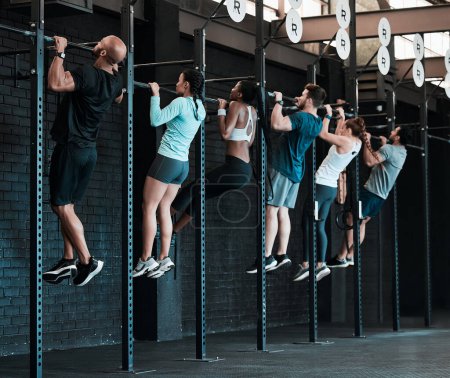 Photo for People, group and exercise with pull ups, training and endurance with fitness, workout goal and motivation. Athletes, men and women with wellness, sports and healthy in a gym, dedication and strength. - Royalty Free Image