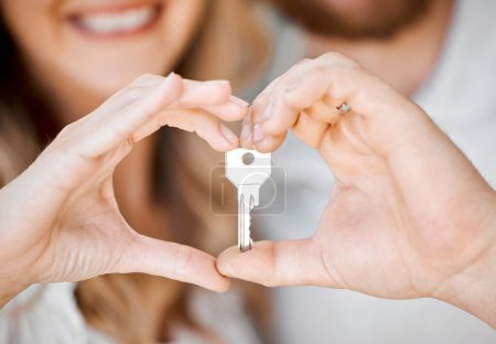Photo for New home, couple and hand heart showing key for moving, love and mortgage celebration. Happiness, emoji and excited hands sign with house and real estate keys together with loving support and joy. - Royalty Free Image