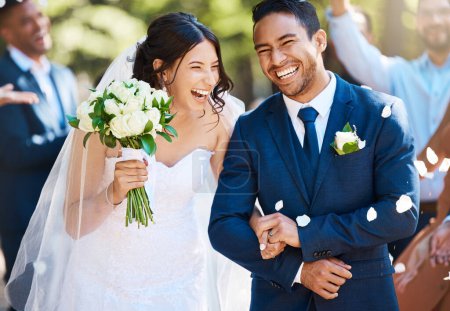 Photo for Love, laughing and couple walking at their wedding with guests in celebration of romance. Happy, smile and young bride with bouquet and groom with crowd celebrating at the outdoor marriage ceremony - Royalty Free Image