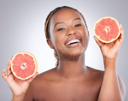 Photo for Portrait, grapefruit and skincare with black woman in studio for natural, cosmetics and vitamin c. Nutrition, diet and detox with female model on grey background for citrus fruit and health product. - Royalty Free Image