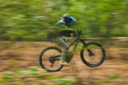 Photo for Motion blur, mountain bike and person cycling in forest for adventure, speed and fast power. Athlete, extreme sports and bicycle for outdoor action, off road transport and cardio race for adrenaline. - Royalty Free Image
