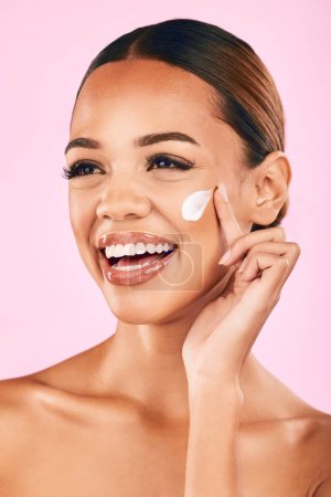 Skincare, beauty cream and face of woman in studio with cosmetics product or dermatology on pink background. Model, skin care or luxury makeup moisturizer, sunscreen or salon facial treatment.