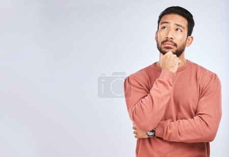 Photo for Man, thinking and idea mockup in studio or planning, decision and choice with white background. Asian male, model and curious face with doubt, questions or confused guy try to remember with space. - Royalty Free Image