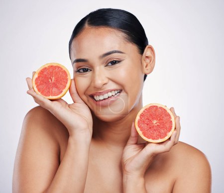Photo for Happy woman, portrait and grapefruit for skincare vitamin C, beauty or cosmetics against a white studio background. Female person smile with fruit in healthy nutrition, natural healthcare or facial. - Royalty Free Image