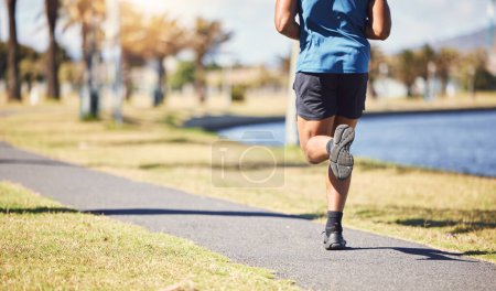 Photo for Fitness, legs and man or runner outdoor for exercise, training or running at a park. Closeup and feet of a male athlete in nature for a workout, run and cardio performance for health and wellness. - Royalty Free Image