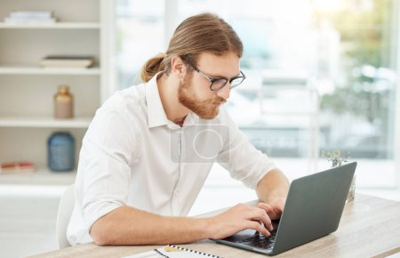 Photo for Typing, computer and business man in office for copywriting, company newsletter and research article or blog. Focus, working and social media writer, editor or person at startup, online and laptop. - Royalty Free Image