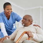 Caregiver, nurse or senior black man on a couch, retirement or help with healthcare or walking stick. Male person with a disability, patient or medical professional with support, recovery or healing.